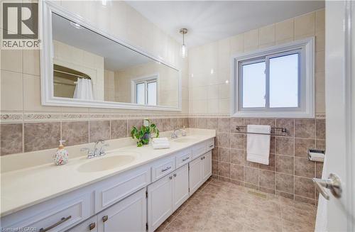 Twin sinks, nicely tiled surfaces keeps things clean. - 63 Kingston Crescent, Kitchener, ON - Indoor Photo Showing Bathroom