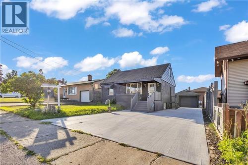 View of front of house with an outdoor structure and a garage - 84 Avalon Place, Kitchener, ON - Outdoor With Facade
