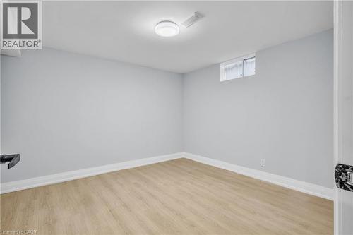 Below grade area with light wood-style floors and baseboards - 84 Avalon Place, Kitchener, ON - Indoor Photo Showing Other Room