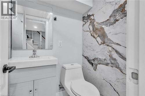 Half bathroom featuring vanity and toilet - 84 Avalon Place, Kitchener, ON - Indoor Photo Showing Bathroom