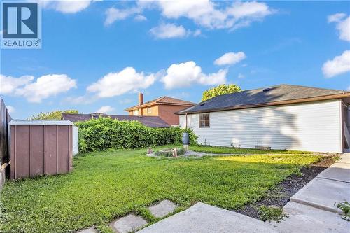 View of green lawn featuring a storage unit - 84 Avalon Place, Kitchener, ON - Outdoor