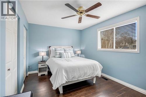 Bedroom with multiple closets, dark wood-style flooring, and ceiling fan - 8 Brantdale Avenue, Hamilton, ON - Indoor Photo Showing Bedroom