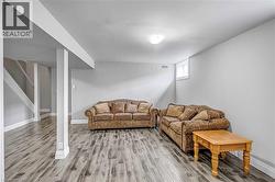 Living area featuring stairway and light wood-style floors - 