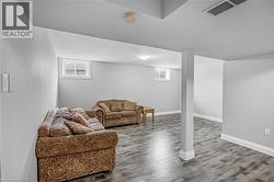 Living room with baseboards and wood finished floors - 