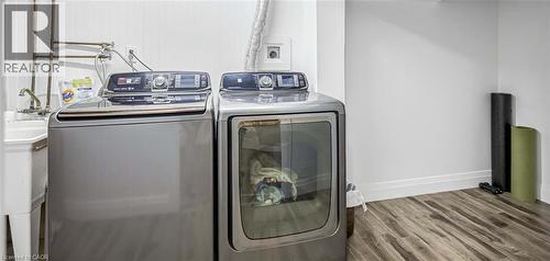Laundry room with wood finished floors and separate washer and dryer - 8 Brantdale Avenue, Hamilton, ON - Indoor Photo Showing Laundry Room