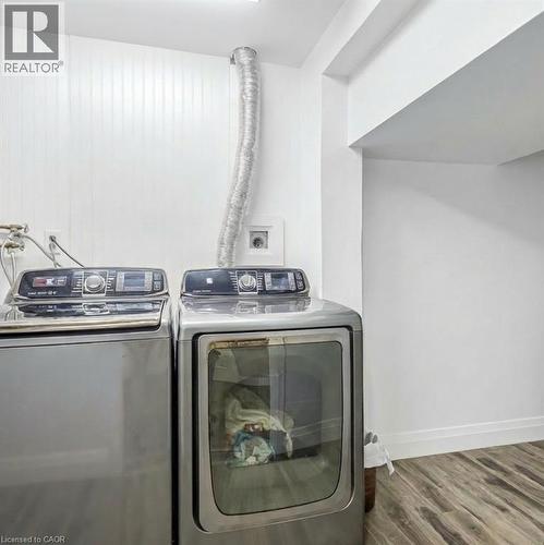 Laundry room featuring washer and dryer and dark wood-type flooring - 8 Brantdale Avenue, Hamilton, ON - Indoor Photo Showing Laundry Room
