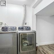 Laundry room featuring washer and dryer and dark wood-type flooring - 