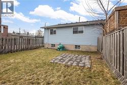 Back of house with a fenced backyard and a patio - 