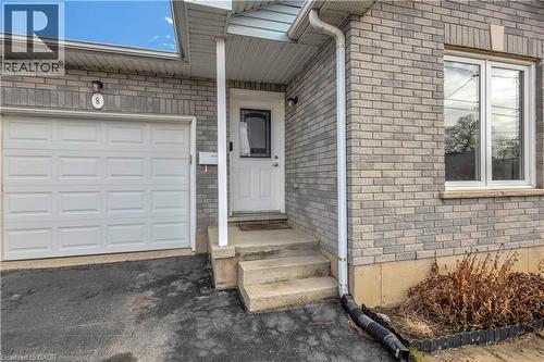 Doorway to property featuring a garage, brick siding, and asphalt driveway - 8 Brantdale Avenue, Hamilton, ON - Outdoor With Exterior