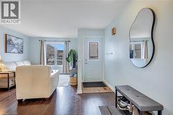 Living area featuring dark wood-type flooring and baseboards - 