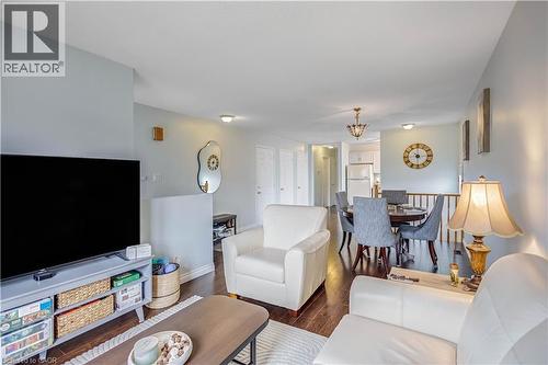 Living area with dark wood-style floors and a chandelier - 8 Brantdale Avenue, Hamilton, ON - Indoor Photo Showing Living Room