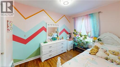 Bedroom with light wood-style flooring and baseboards - 10 Armstrong Avenue, Hamilton, ON - Indoor Photo Showing Bedroom