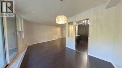 Unfurnished dining area with dark wood-type flooring and baseboards - 