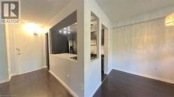Hall featuring dark wood-style floors and baseboards - 