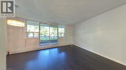 Spare room with baseboards and dark wood-type flooring - 