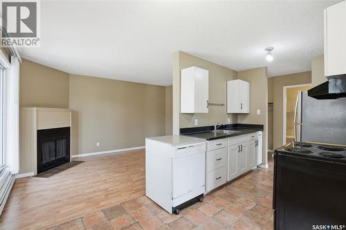 208B 4040 8Th Street E, Saskatoon, SK - Indoor Photo Showing Kitchen With Fireplace