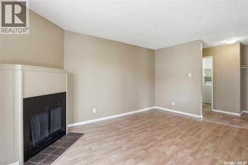 208B 4040 8Th Street E, Saskatoon, SK - Indoor Photo Showing Other Room With Fireplace