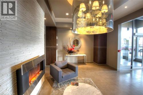 Community lobby with recessed lighting - 191 King Street S Unit# 712, Waterloo, ON - Indoor Photo Showing Other Room With Fireplace