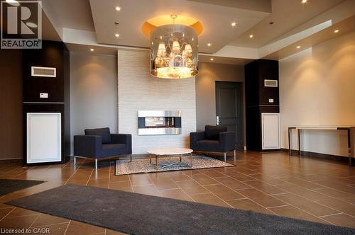Lobby featuring recessed lighting and a tray ceiling - 191 King Street S Unit# 712, Waterloo, ON - Indoor With Fireplace