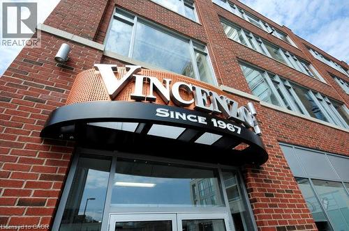 View of building exterior featuring a garage - 191 King Street S Unit# 712, Waterloo, ON - Outdoor With Exterior