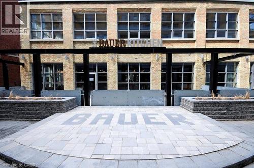 Property entrance featuring brick siding and a patio area - 191 King Street S Unit# 712, Waterloo, ON - Outdoor With Facade