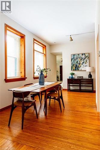 Dining area with light wood finished floors and baseboards - 218 Bay Street S, Hamilton, ON 