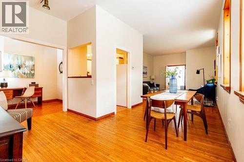 Dining area with light wood-type flooring and baseboards - 218 Bay Street S, Hamilton, ON 