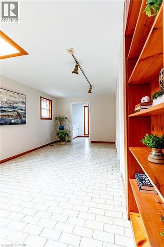 Unfurnished room with rail lighting and baseboards - 218 Bay Street S, Hamilton, ON 