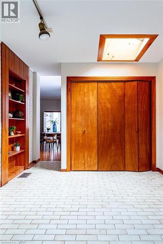 Bedroom with a closet and brick patterned flooring - 218 Bay Street S, Hamilton, ON 