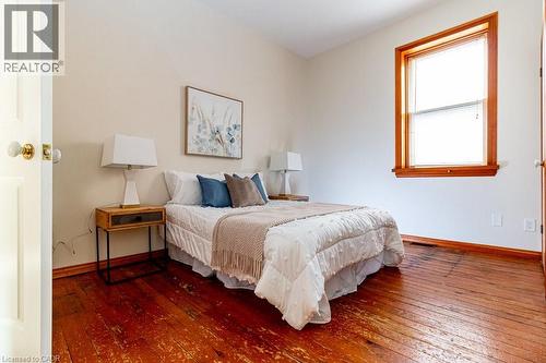 Bedroom with wood-type flooring and baseboards - 218 Bay Street S, Hamilton, ON 