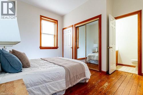 Bedroom with hardwood / wood-style flooring and a closet - 218 Bay Street S, Hamilton, ON 