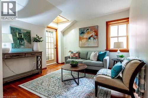 Living area featuring wood finished floors and baseboards - 218 Bay Street S, Hamilton, ON 