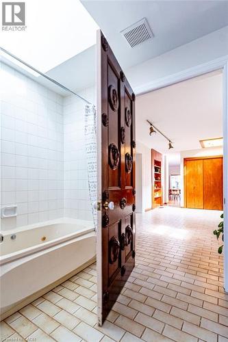 Bathroom with shower / bath combo with shower curtain and rail lighting - 218 Bay Street S, Hamilton, ON 