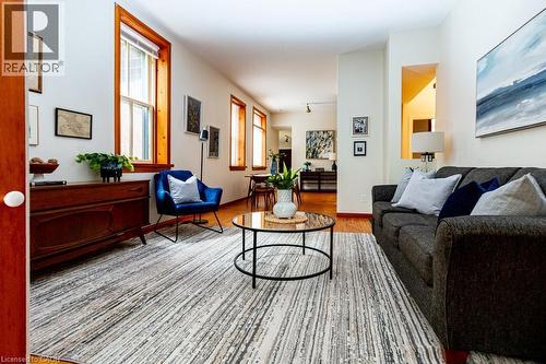 Living area with light wood-type flooring and baseboards - 218 Bay Street S, Hamilton, ON 