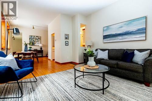 Living area featuring light wood finished floors and baseboards - 218 Bay Street S, Hamilton, ON 