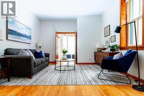 Living room featuring light wood-type flooring and baseboards - 218 Bay Street S, Hamilton, ON 