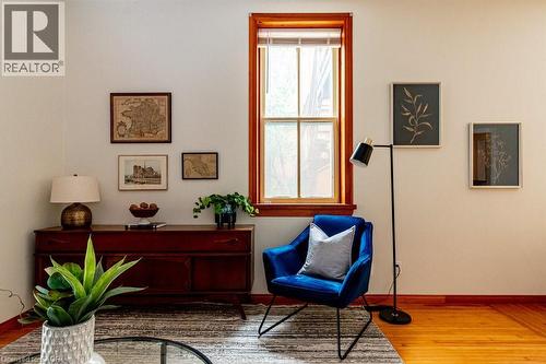 Living area featuring light wood-type flooring and baseboards - 218 Bay Street S, Hamilton, ON 