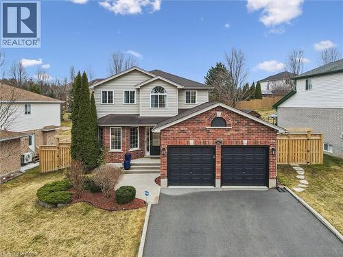 Traditional home with driveway, brick siding, a garage, and roof with shingles - 68 Newman Drive, Cambridge, ON - Outdoor