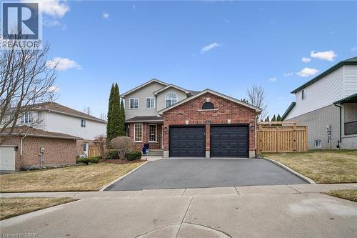 Traditional-style home with driveway, brick siding, and an attached garage - 68 Newman Drive, Cambridge, ON - Outdoor