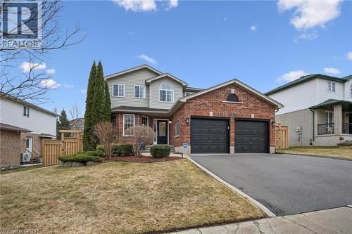Traditional-style house with brick siding, asphalt driveway, an attached garage, and a gate - 68 Newman Drive, Cambridge, ON - Outdoor With Facade