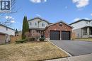 Traditional-style house with brick siding, asphalt driveway, an attached garage, and a gate - 68 Newman Drive, Cambridge, ON  - Outdoor With Facade 