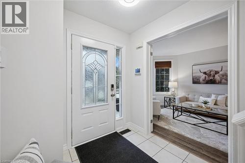 Foyer entrance with light tile patterned floors and baseboards - 68 Newman Drive, Cambridge, ON - Indoor Photo Showing Other Room