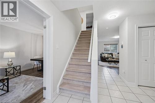 Stairway featuring tile patterned flooring and baseboards - 68 Newman Drive, Cambridge, ON - Indoor Photo Showing Other Room
