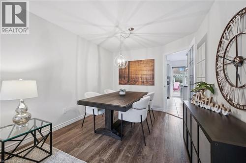 Dining space featuring dark wood-style floors and hanging lights - 68 Newman Drive, Cambridge, ON - Indoor