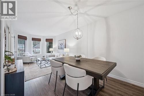Dining space with dark wood-style flooring and suspended lighting - 68 Newman Drive, Cambridge, ON - Indoor Photo Showing Dining Room