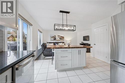 Kitchen featuring butcher block countertops, stainless steel appliances, a center island, open floor plan, and a kitchen breakfast bar - 68 Newman Drive, Cambridge, ON - Indoor Photo Showing Kitchen