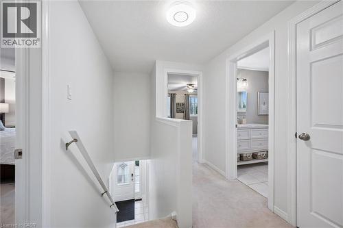 Hallway featuring light carpet, an upstairs landing, a textured ceiling, and light tile patterned flooring - 68 Newman Drive, Cambridge, ON - Indoor Photo Showing Other Room