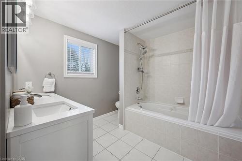 Bathroom featuring double vanity, light tile patterned floors, and tiled shower / bath - 68 Newman Drive, Cambridge, ON - Indoor Photo Showing Bathroom