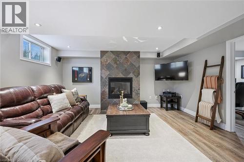 Living room with light wood-type flooring, a tile fireplace, and recessed lighting - 68 Newman Drive, Cambridge, ON - Indoor Photo Showing Living Room With Fireplace