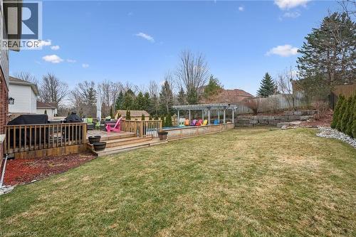 Fenced backyard featuring a deck and a swimming pool - 68 Newman Drive, Cambridge, ON - Outdoor